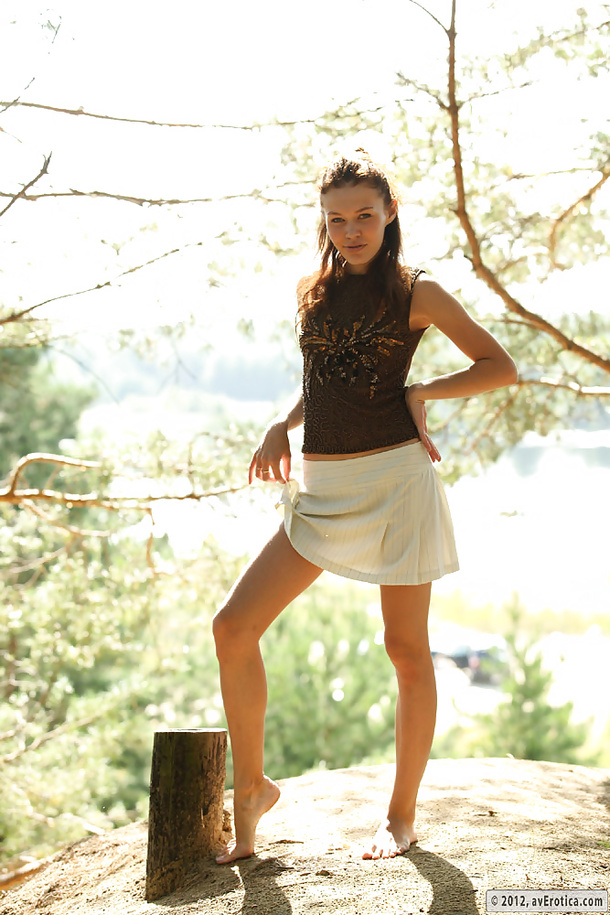 Tanned exibicionist Brigitte poses in pine forest - Picture 00