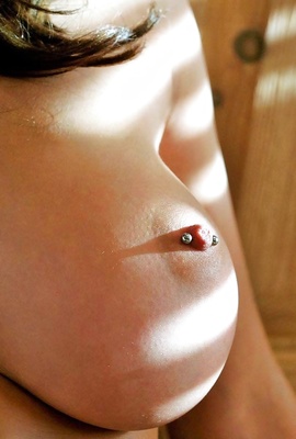 Pierced close-up nipple of Christine looks tasty